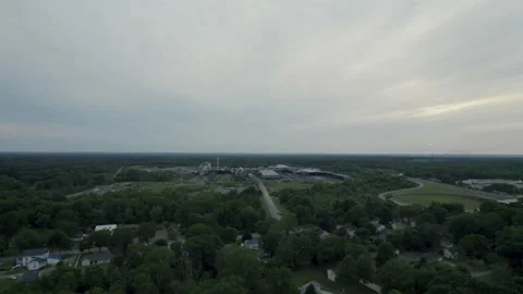 Drone view of beautiful town covered by trees in evening Stock Footage 201849574