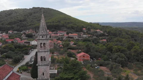Drone view of a bell tower in the mountains 07 Stock Footage