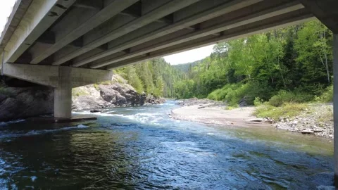 Drone View Beneath Concrete Bridge Crossing the Assemetquagan River Video stock 342814420