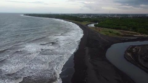 Drone view of a black volcanic sand beach and river mouth on the coast of E.. 스톡 동영상 341312933