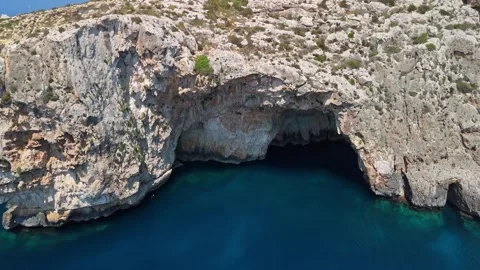 Drone view of the Blue Grotto's cliffs and turquoise water in southern Malta Stock Footage 337001110