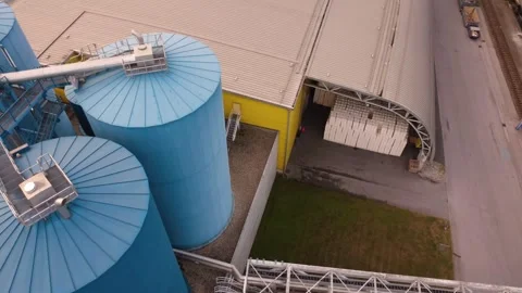 Drone view of blue storage silos and stacked paper at an industrial paper mill Vídeo Stock 344734701