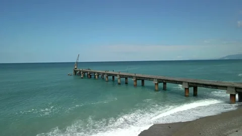 Drone view of the bridge in the beautiful black sea on which there is a crane Stock Footage 237597297