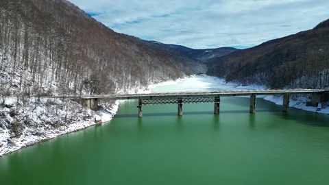 Drone View of Bridge Crossing Emerald Mountain River During Early Spring Thaw Stock Footage 330240110
