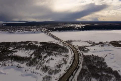 Drone view on the bridge over the river covered with ice and snow Stock Photos
