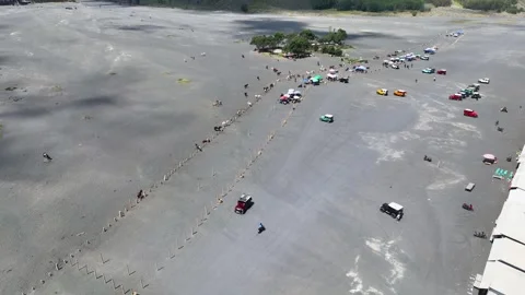 Drone view of the Bromo volcano road filled with hundreds of colorful jeeps Stock Footage 329374646