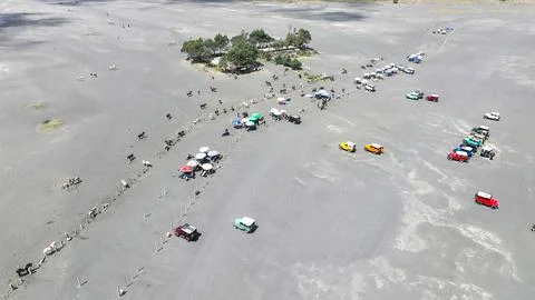 Drone view of the Bromo volcano road filled with hundreds of colorful jeeps Stock Photos