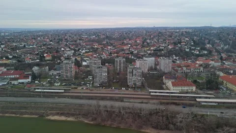 Drone view of Budafok’s residential blocks, roads, and railway under clouds Stock Footage 336468535