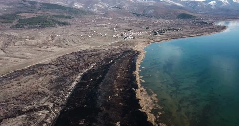 Drone view of a burned reed on a shore of lake ohrid in macedonia Video stock 106194015