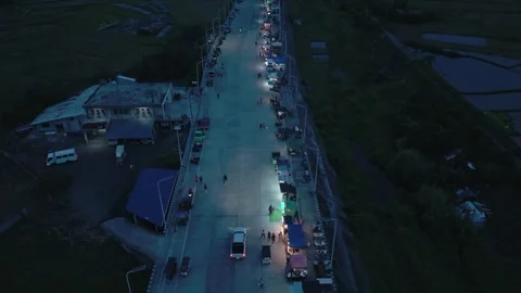 Drone view of bustling evening market and illuminated road in the Philippines Video stock 336907095