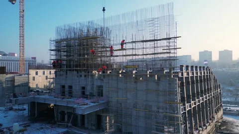 Drone view of busy builders working on construction site. Stock Footage 299572723