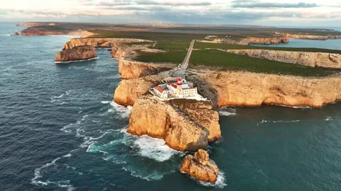 Drone view of Cabo de Sao Vicente lighthouse at sunset over water Stock-Footage 344288442