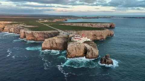 Drone view of Cabo de Sao Vicente Lighthouse at dusk with cape scenery Stock Footage 344956605