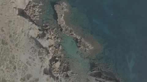 Drone view of cala Na Xeringa crystal-clear sea waters in Menorca - DLog Stock Footage 246586828