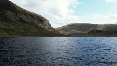 Drone view of calm scottish lake during hike Video stock 246970018