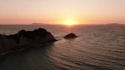 Drone view of Cape Drastis sea stacks glowing at sunset in Corfu. Stock Footage 340927929