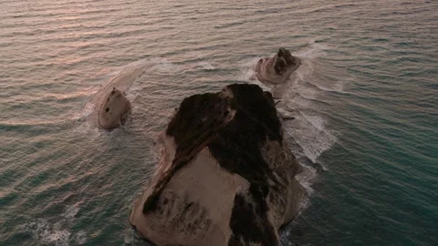 Drone view of Cape Drastis sea stacks bathed in warm sunset light. Stock Footage 340929124