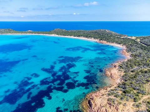 Drone view of Capo Coda Cavallo shore under a blue sky Stock Photos