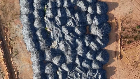 Drone view captures stacked concrete blocks on dirt ground Stock Footage 344048806