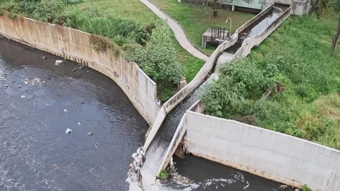 Drone view captures wastewater being discharged into a large drainage canal.. Stock Footage 329313123
