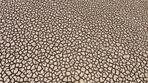 Drone view capturing a severely dried up terrain with deep cracks. Stock Footage 274376219