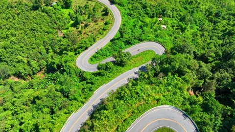 A drone view of a car driving along a dangerous winding mountain road. Stock Footage 320040555