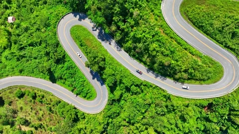 A drone view of a car driving along a dangerous winding mountain road. Stock Footage 320040591