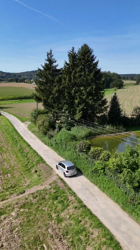 Drone view of car driving on rural country road with fields and trees Vídeos de archivo 340336271