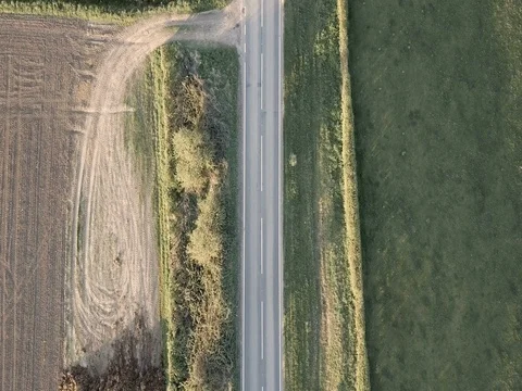 Drone view of car driving through countryside Stock Footage 79250147
