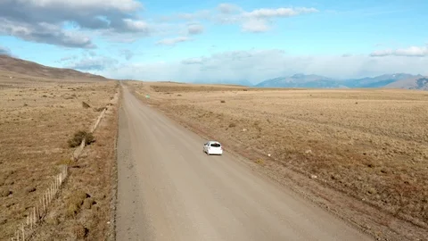 Drone view of a car driving through a sand road in Patagonia Stock Footage 111831447
