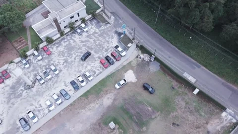 Drone view car exiting parking lot entering street urban traffic Stock-Footage 336643560