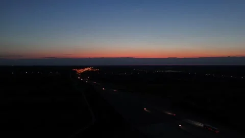 Drone View of Car Lights on Highway at Dusk With Red Sky Stock Footage 317050932