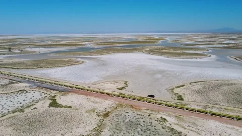 Drone view of car moving along road on dead salt lake Tuz in Turkey 스톡 동영상 252642947