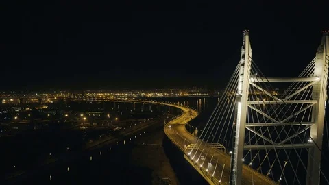 Drone view car moving on modern hanging bridge in night city with illumination Stock Footage 84718189