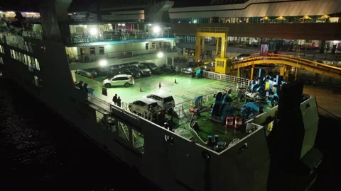 DRONE VIEW CARS GOING INSIDE OF SHIP AT MERAK Stock Footage 239379585