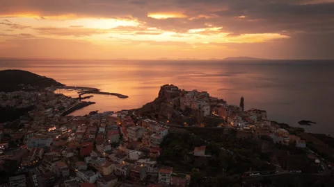 Drone view of Castelsardo old town and evening city lights at sunset Stock Footage 287883516