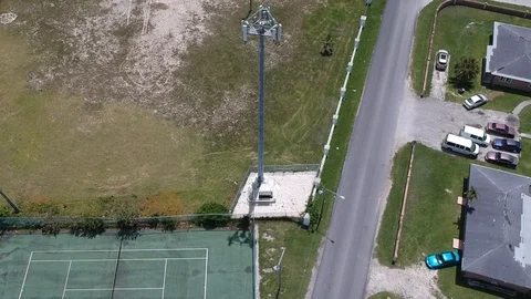 Drone View of Cellular Tower Surrounded by Residential Community, Bahamas Stock Footage 90105650