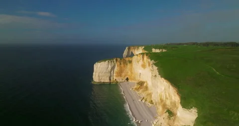 Drone view of the chalk cliffs on the seashore. People walk along the green Stock Footage 241077463