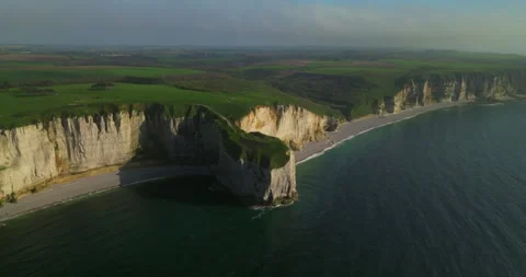 Drone view of the chalk cliffs on the seashore. People walk along the green Stock Footage 241363335