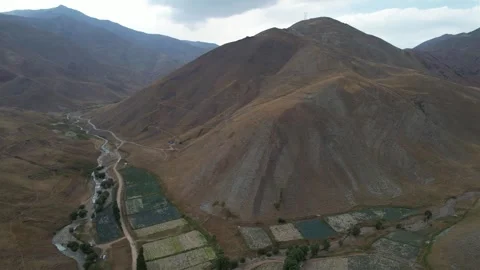 Drone view of Chalus Road terraces and fields stepping down a mountain valley Stock Footage 343907281