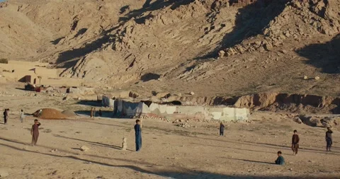 Drone view of children playing cricket in the mountains of Quetta, Pakistan Stock Footage 232012143