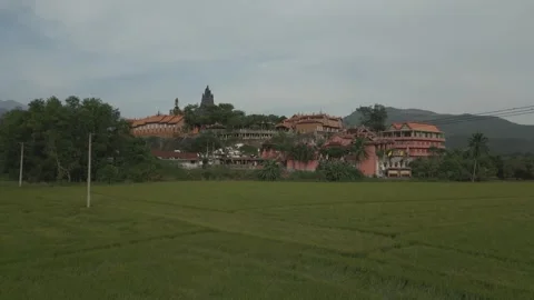 Drone view of Chua da Mai Buddhist pagoda in Vietnam amid lush fields Video stock 308265181