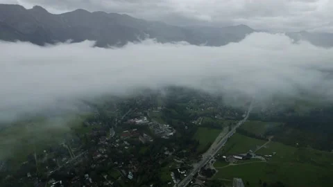 Drone view of the city in mountains the clouds, 4k 10 bit Stock Footage 225855786