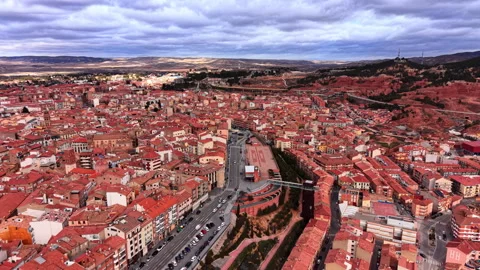 Drone view of city skyline with main boulevard and red rock ravine, Teruel, Stock Footage 337465416
