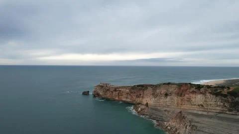 Drone view of cliff and lighthouse in Nazare, Portugal Vídeo Stock 265442418