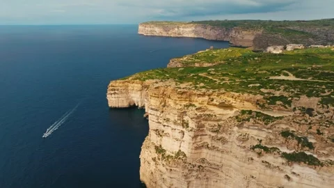 Drone view of cliffs on Gozo island. Rocks, sea, boat. Malta island Stock Footage 329986390