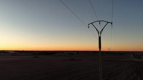 Drone view in close-up flight of the detail of a power line next to a road in Stock Footage 261383793