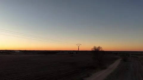 Drone view in close-up flight of a power line next to a road in the middle of Stock Footage 261383759