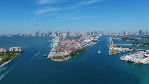 Drone view of coastal area with clear blue sky, body of water and urban Stock Footage 282260343