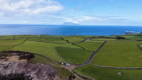 Drone View Of Coastal Farmland With Distant Corvo Island In The Azores Portugal Video stock 337698449